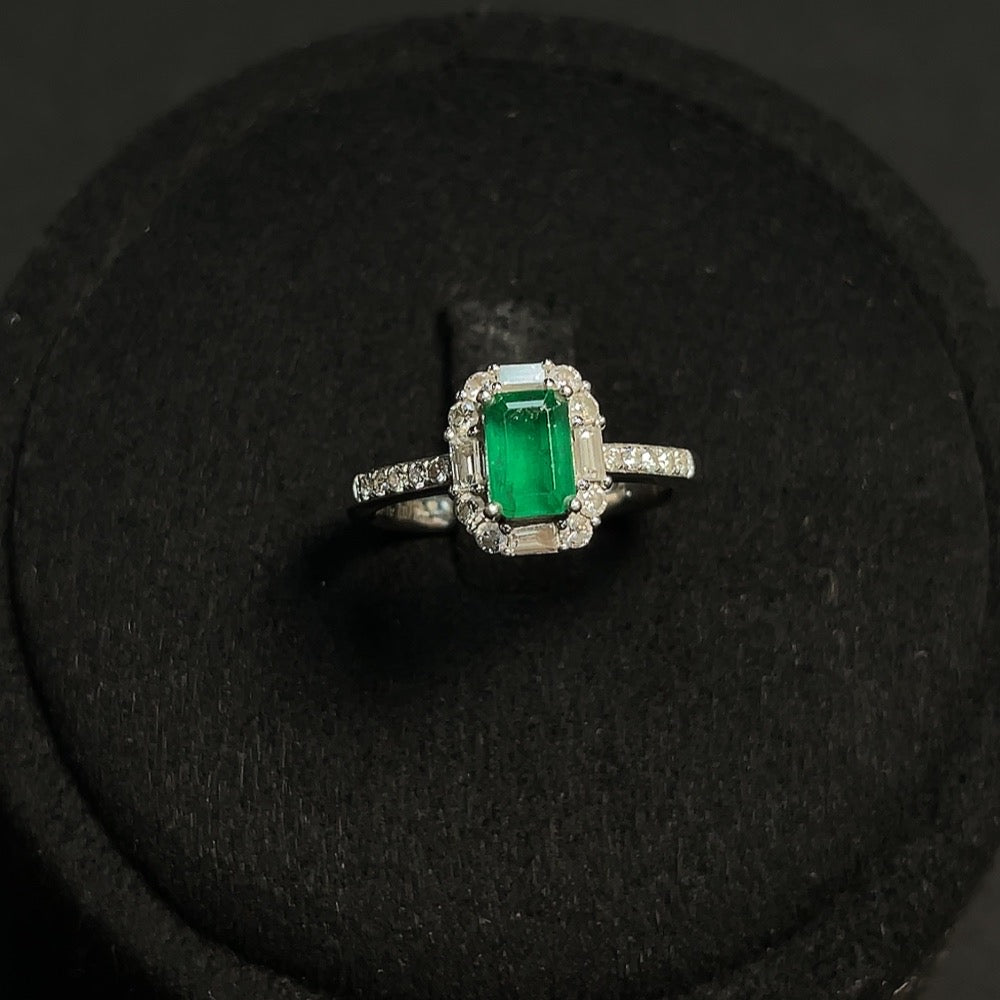 Emerald gemstone ring by HKHQ in 18K gold, size 10, with diamond accents and clarity-enhanced emerald.