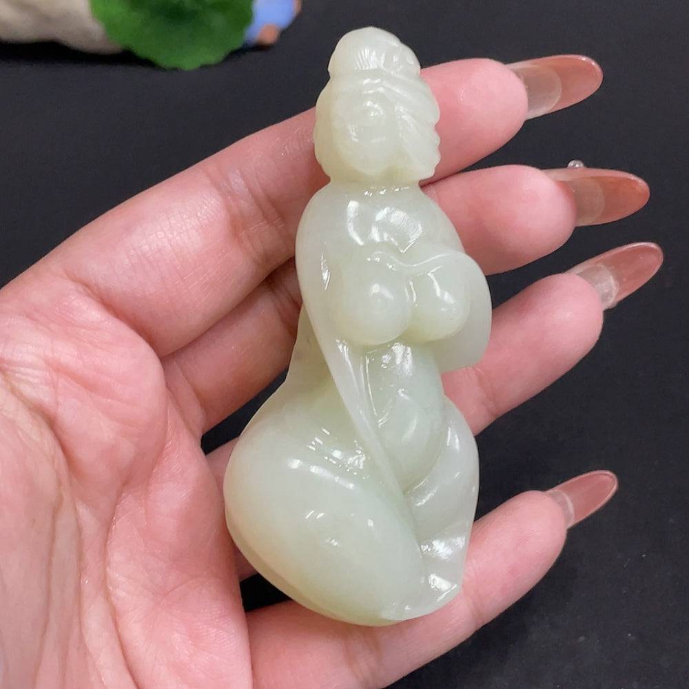 HUILIU HQ Hetian jade handheld piece showcasing intricate craftsmanship and smooth, polished jade in a natural hue.