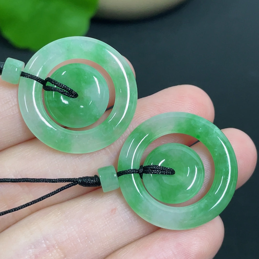 Jadeite pendant featuring mother-and-child buckle design with cord, crafted by HKHQ, weighing approximately 6.11g.