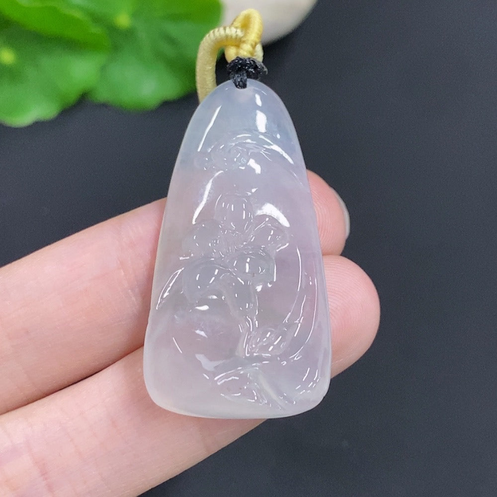 Jadeite Flower of Wealth and Honor pendant featuring intricate jade carving, displayed on a soft fabric background.