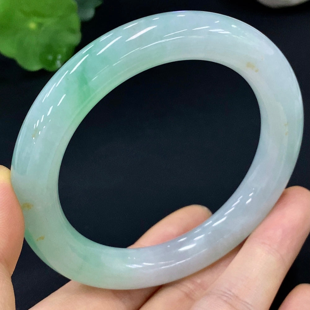 Huiliu certified jadeite round bangle showcasing smooth, polished green jade with a glossy finish.