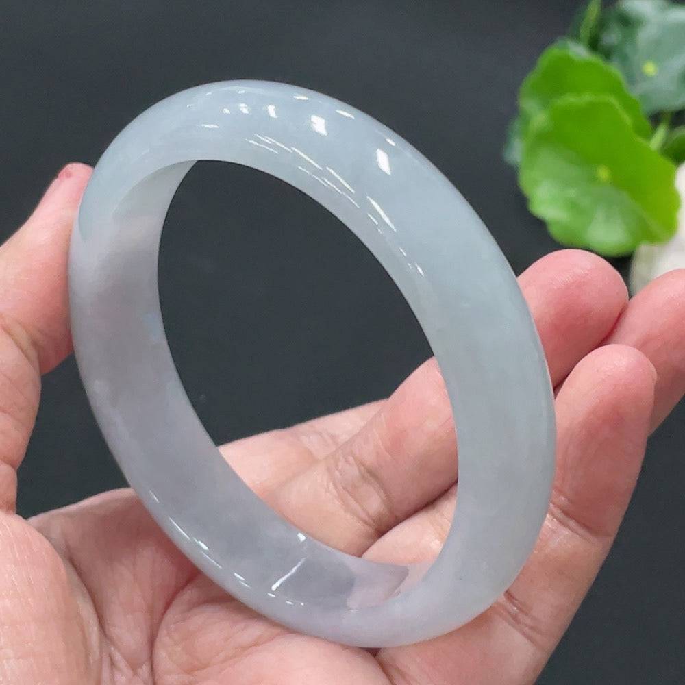 HUILIU HQ jadeite round bangle weighing about 56g and size 57.9, featuring smooth, polished jadeite surface with a natural green hue.