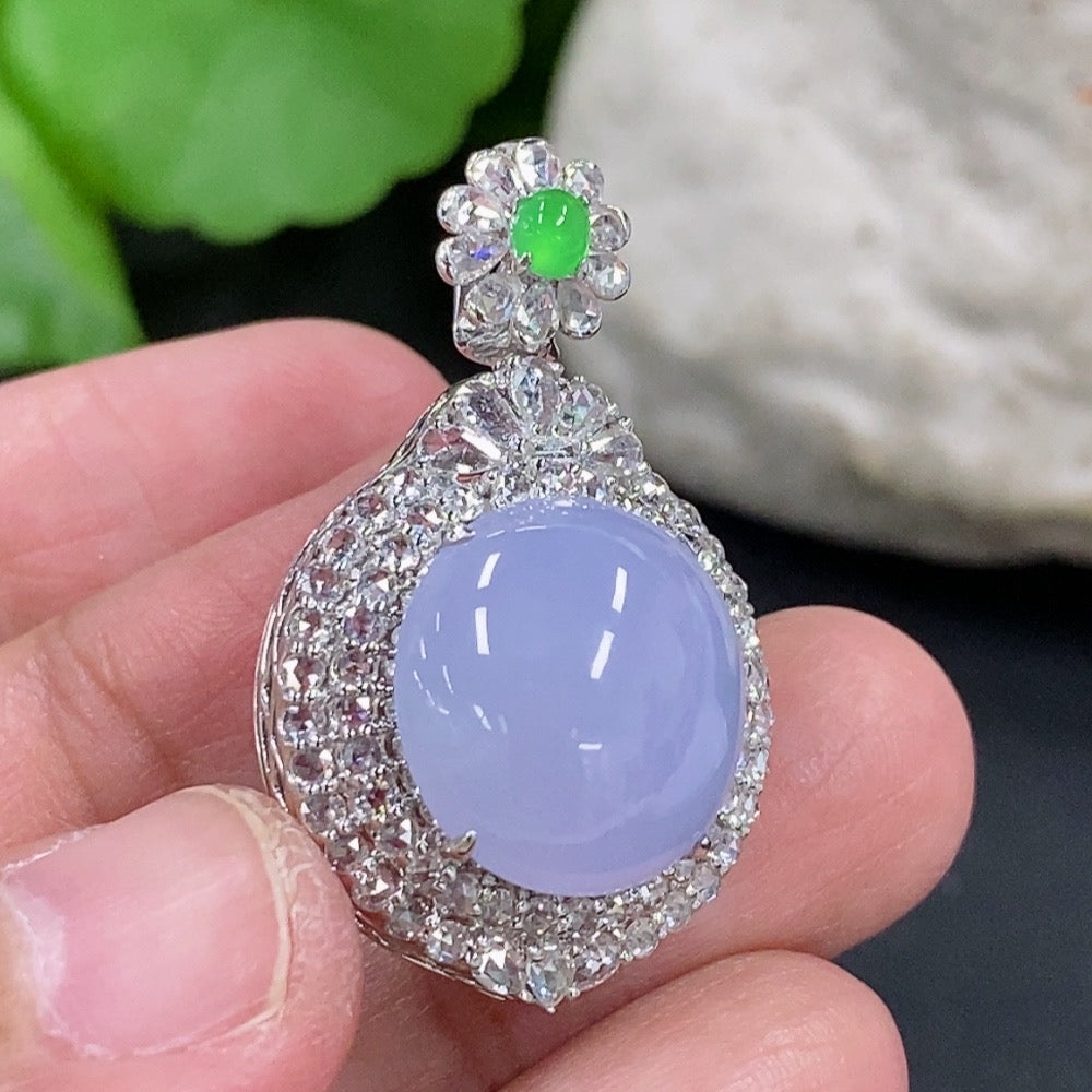 Jadeite cabochon pendant with 18K gold setting and diamond accents, elegant necklace featuring a polished green gemstone.