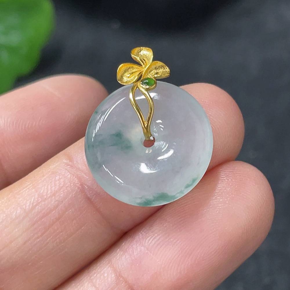 Jadeite peace knot pendant with 18k gold clasp, weighing approximately 2.74g, showcasing intricate jade craftsmanship.