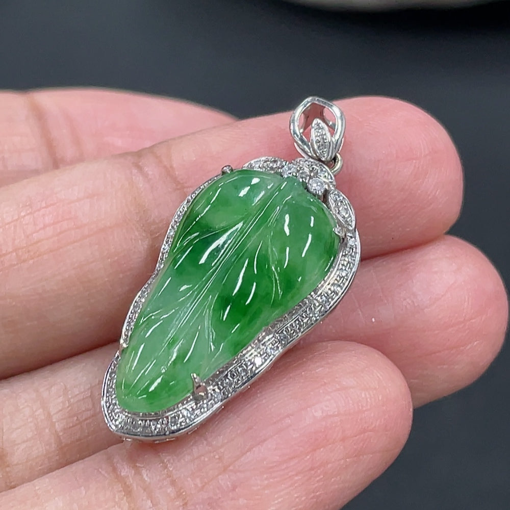 Jadeite leaf inlay pendant with 18k gold and diamond accents, showcasing intricate craftsmanship and natural green jade imagery.