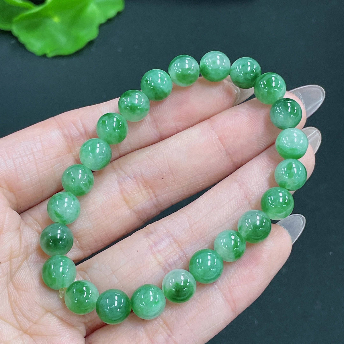 Jadeite bracelet featuring 7.8mm jade beads with mineral components, weighing approximately 19.23g, by HUILIU HQ.