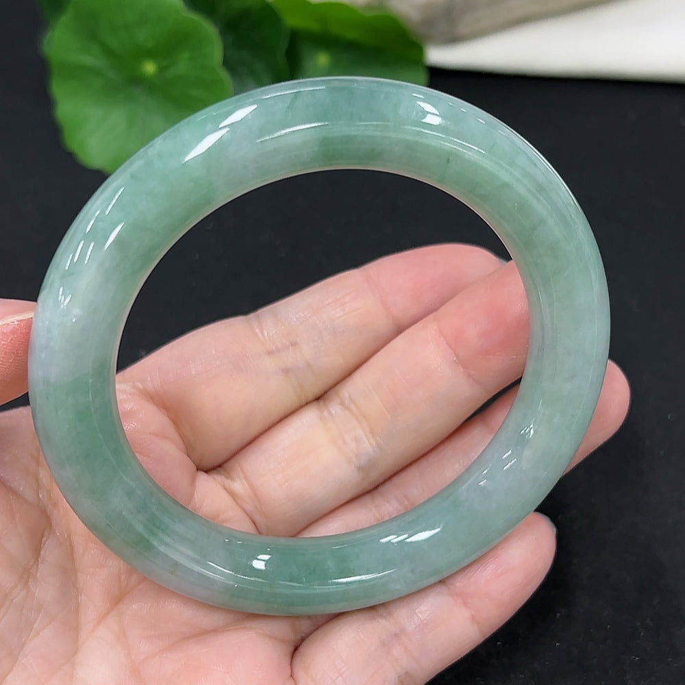 HKHQ jadeite round bangle, size 57.7, weighing 68.6g, showcasing smooth, polished green jadeite bracelet with intricate details.