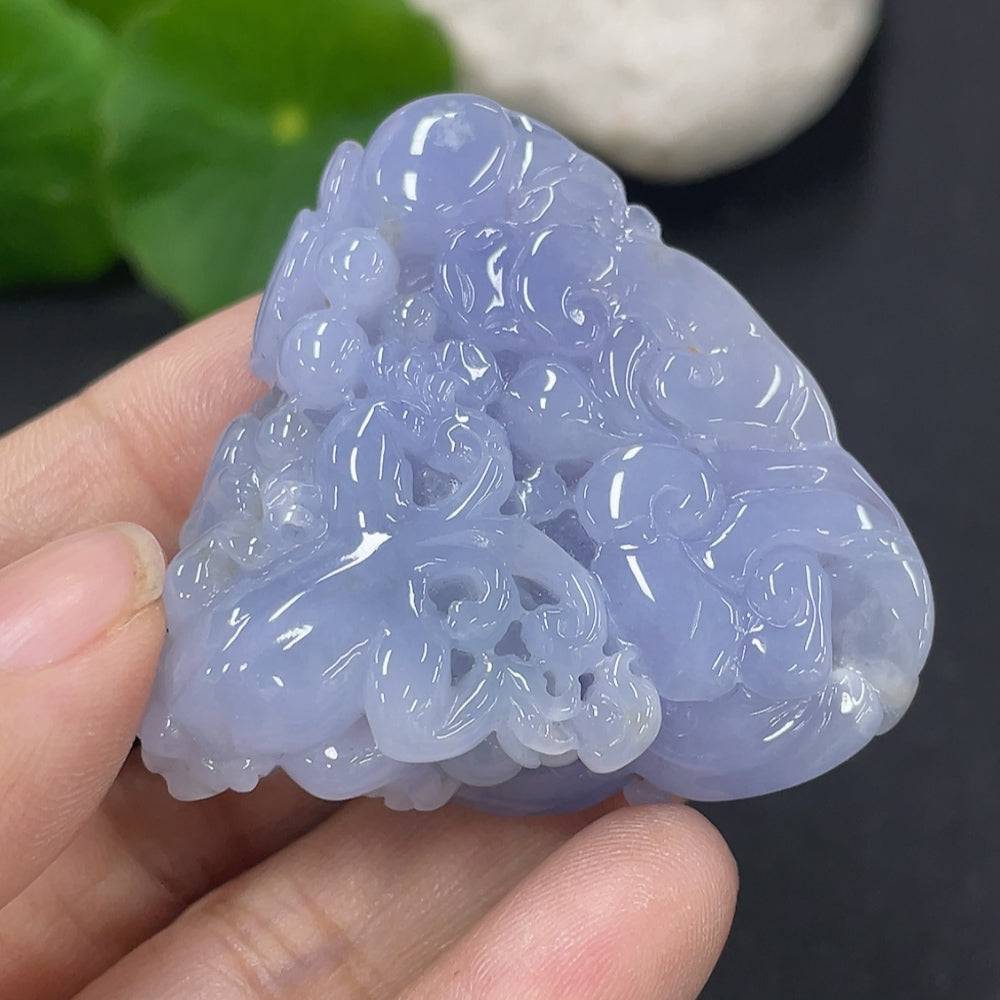 Huiliu Certified Jadeite pendant featuring a smooth, polished green jade stone with intricate carving details.