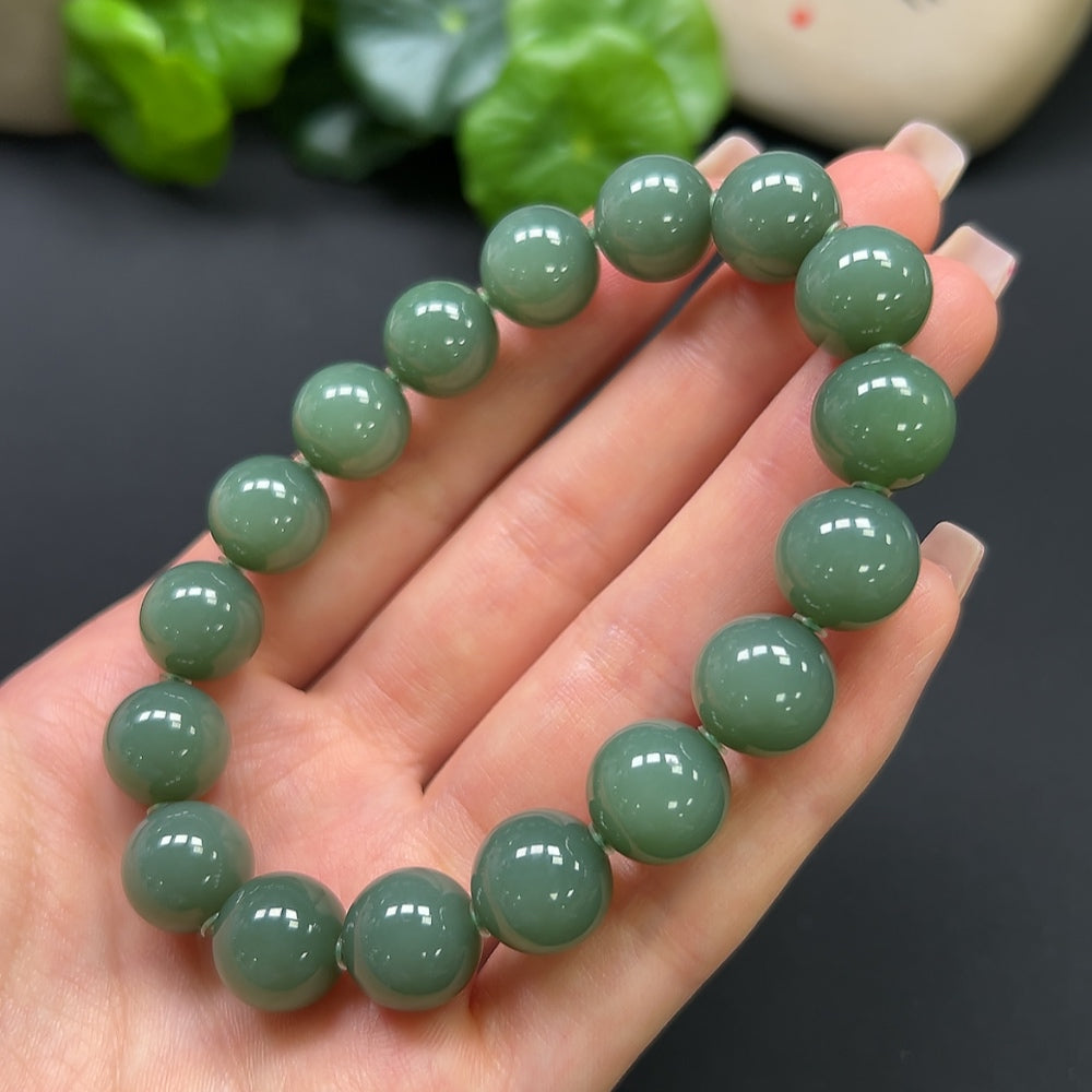 HKHQ Hetian Jade bracelet weighing 45g, featuring polished green jade beads and a secure clasp, displayed on a neutral background.