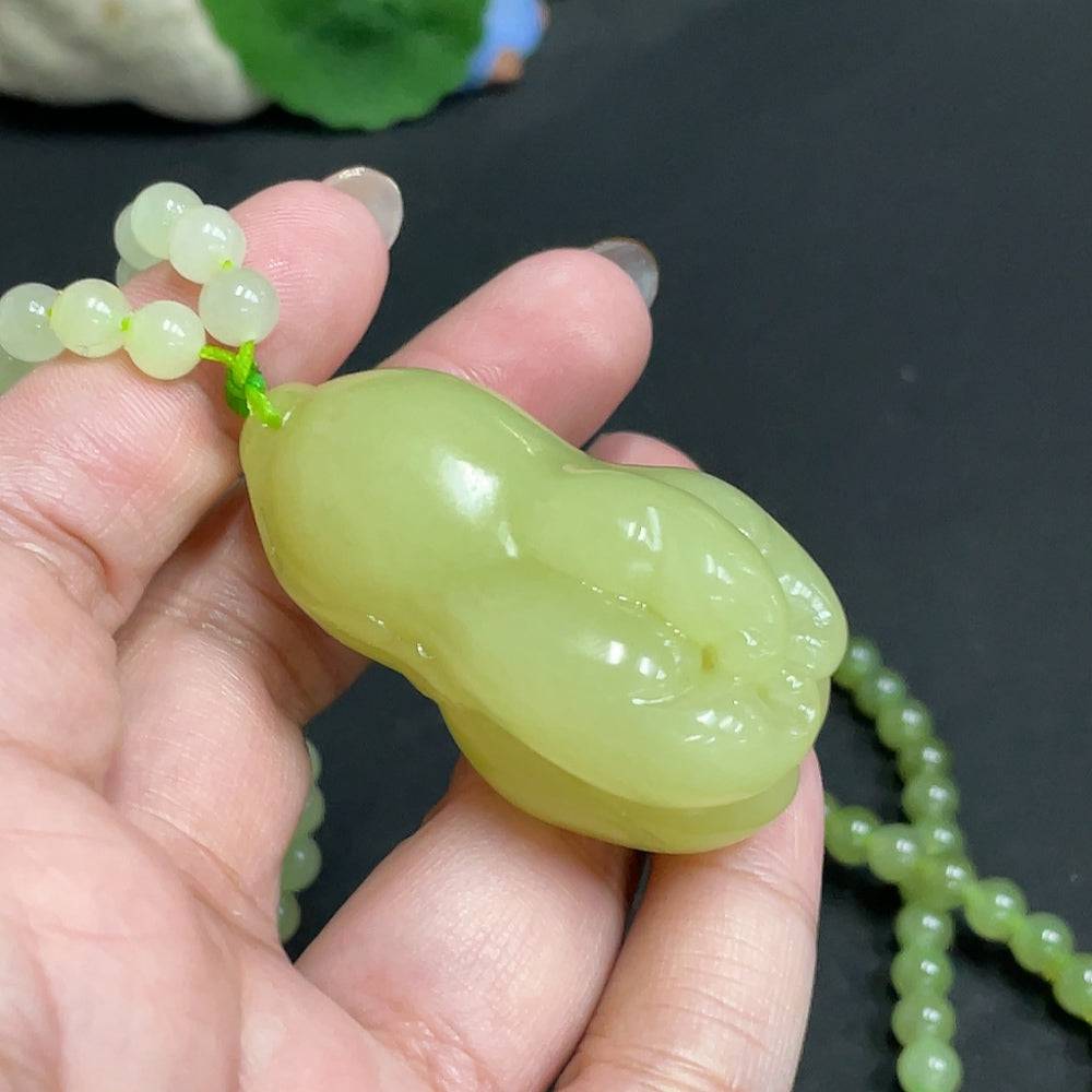 Huiliu certified Hetian jade pendant with chain featuring a smooth, polished Bergamot-shaped jade stone on a silver chain