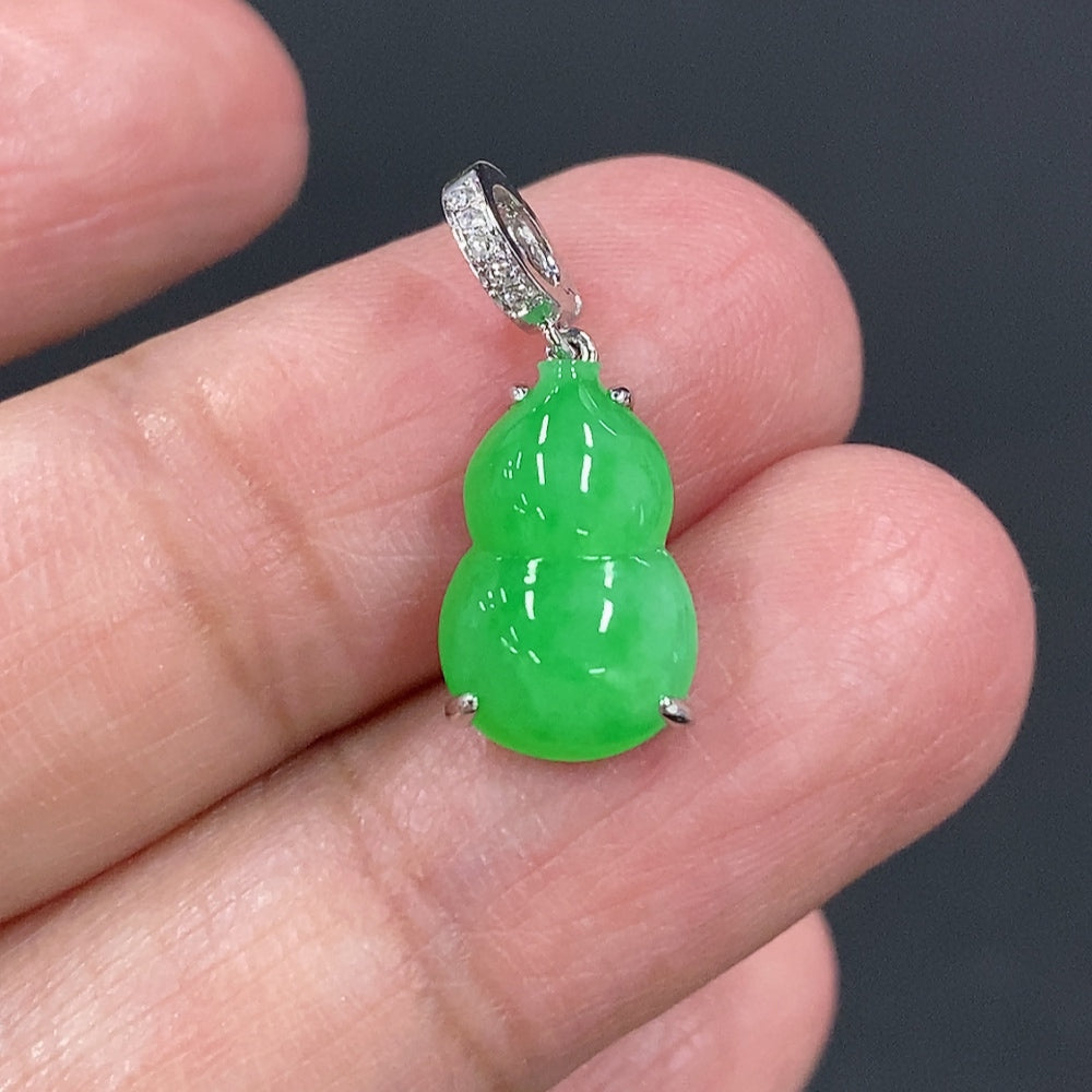 Jadeite gourd pendant with 18K gold and diamond accents, featuring intricate inlay work and a delicate design.