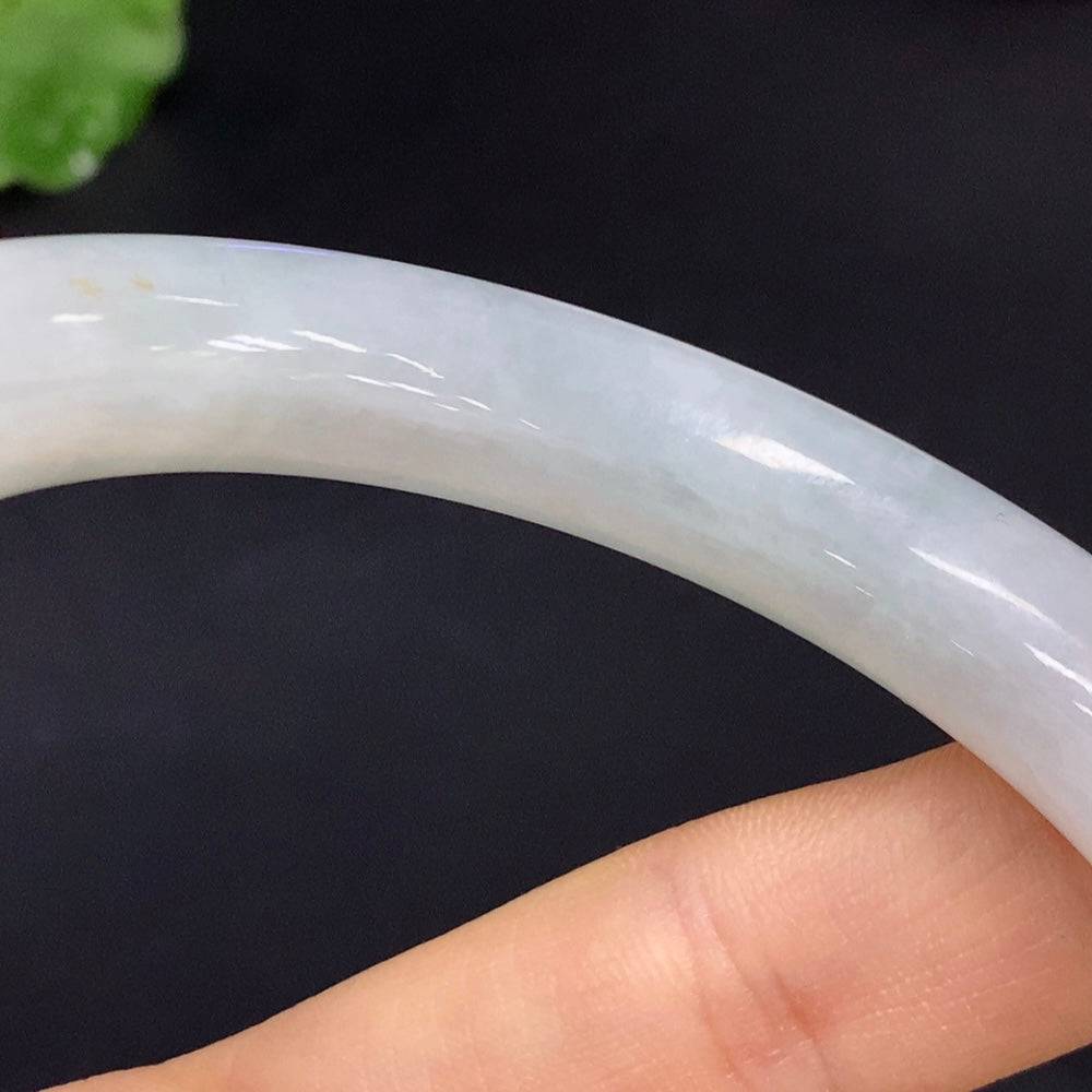 Huiliu Certified Jadeite round bangle showcasing smooth, polished jade surface and vibrant green color.