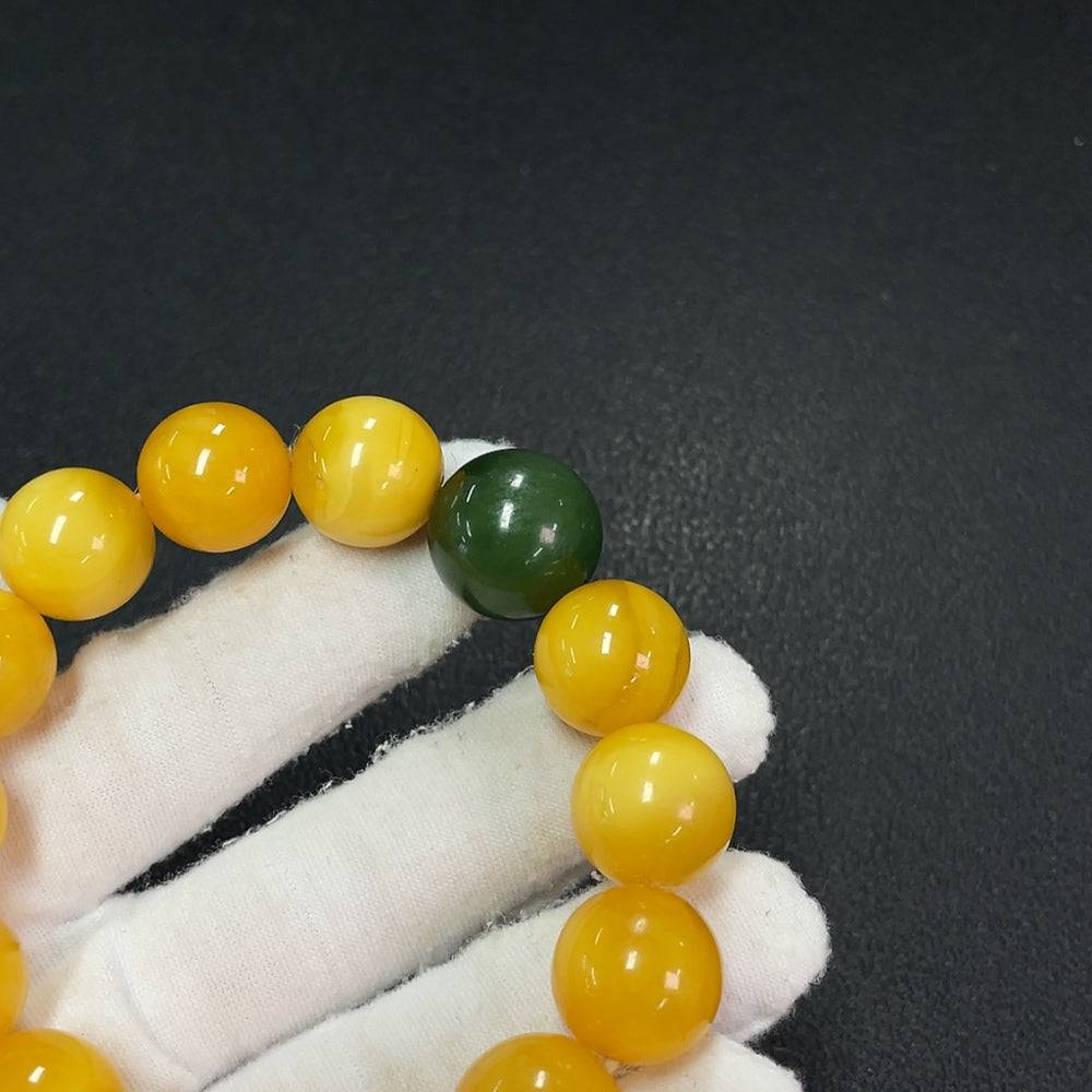 Amber beeswax bracelet with Hetian jade beads, about 15mm, featuring partial repair, from HUILIU HQ.