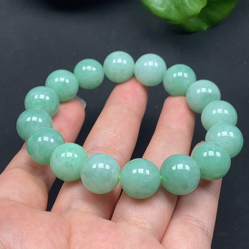 HKHQ jadeite bracelet with 12.8-inch size, featuring polished green jade stones, weighing approximately 57.85 grams.