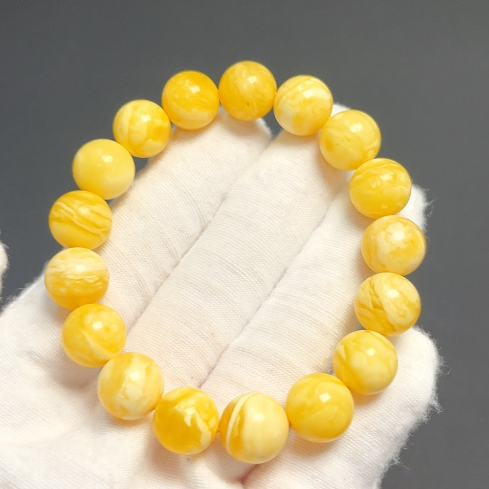 Amber beeswax bracelet by HUILIU HQ featuring 11.4mm beads and a total weight of 13.48g, showcasing warm amber tones and craftsmanship.