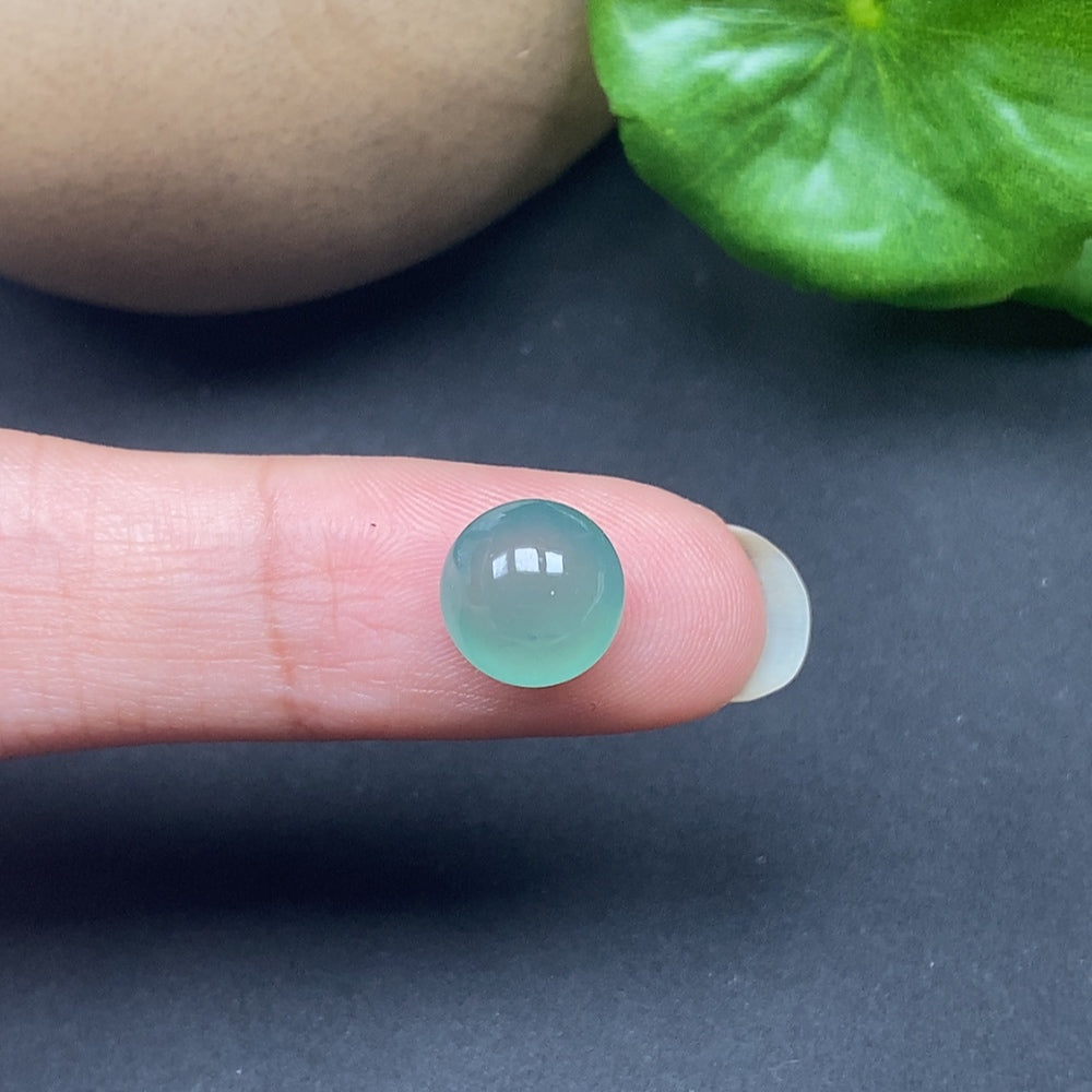 Close-up of a Jadeite cabochon inlay from HKHQ, showcasing smooth, polished jade with natural green hues and intricate craftsmanship.