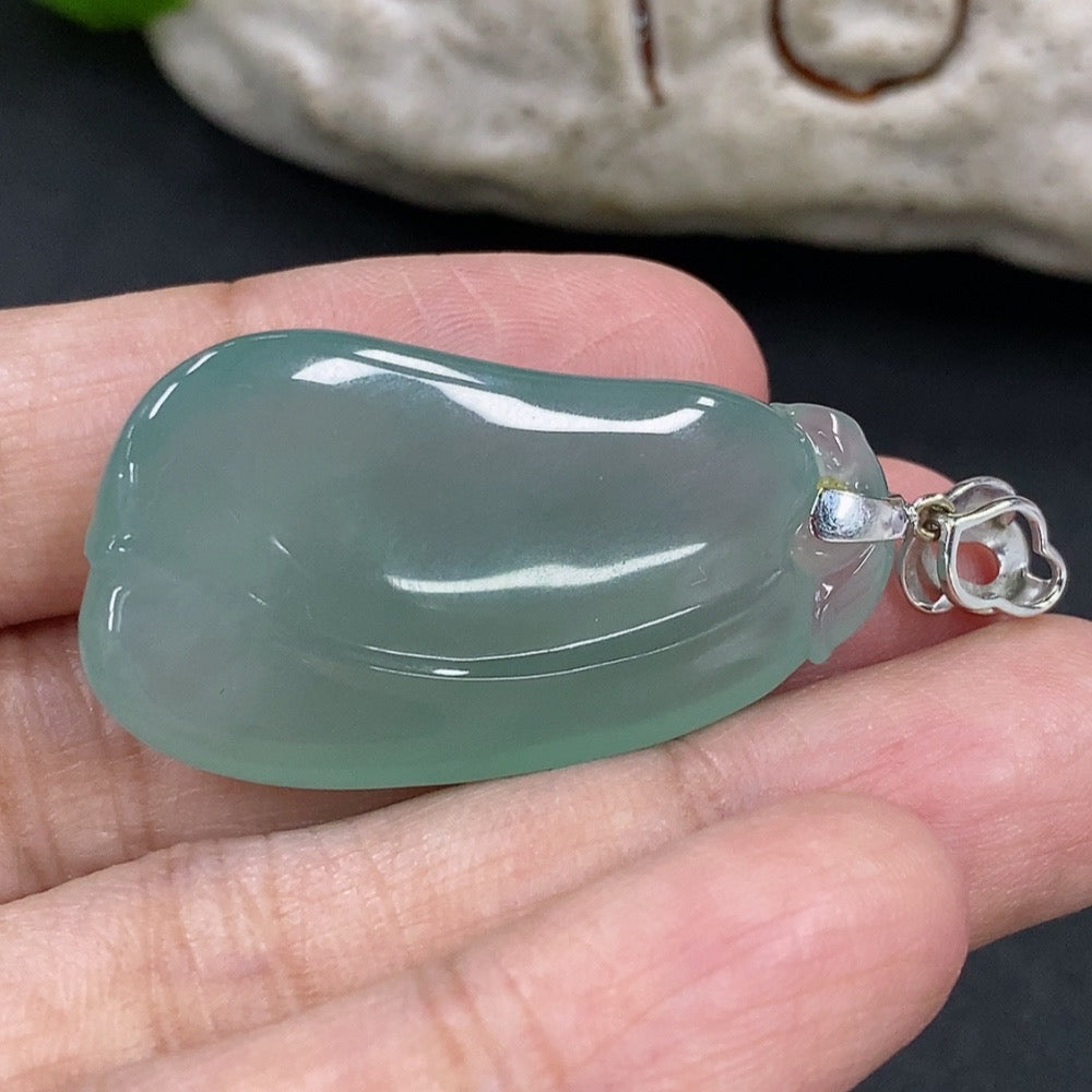 Jadeite pendant featuring blessing melon design with 18K gold and diamond accents, on a necklace chain.