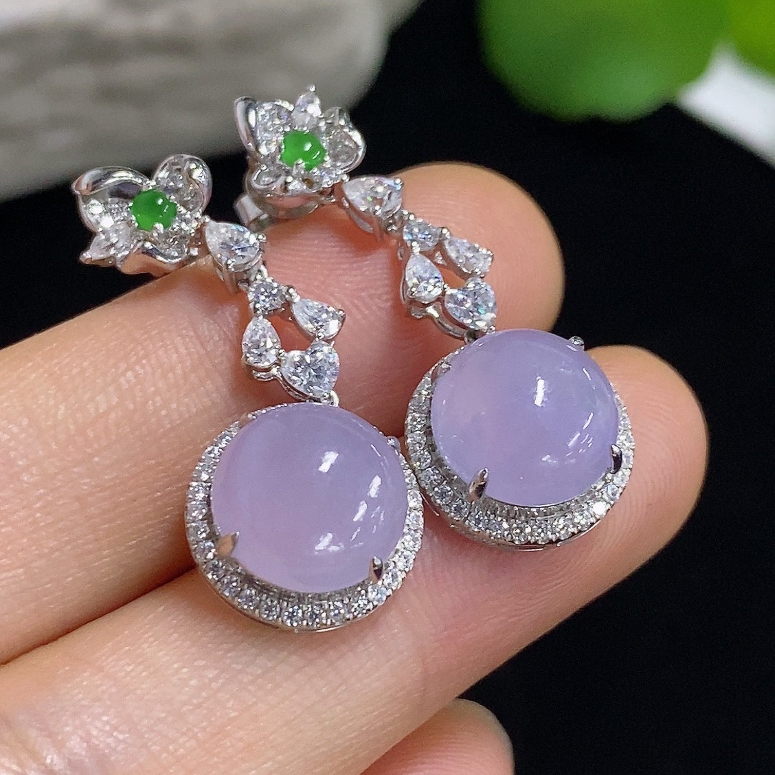 HKHQ jadeite cabochon earrings with 18K gold setting, showcasing smooth, polished green jade stones in a stylish earring design.