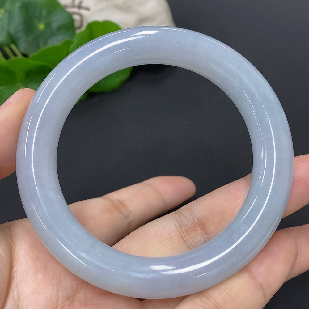 Huiliu certified jadeite round bangle showcasing smooth, polished jade with a natural green hue and elegant circular design.