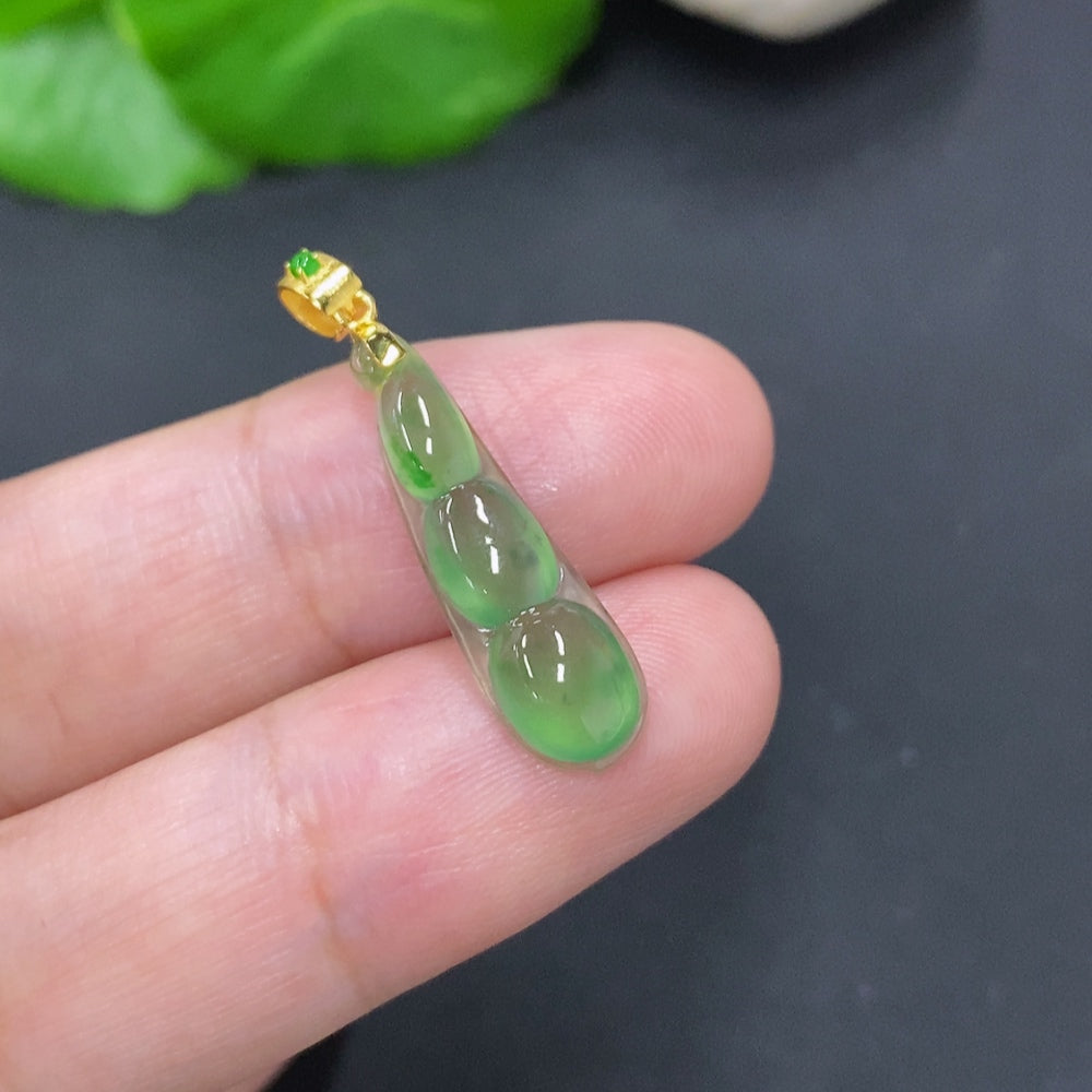 Jadeite lucky bean pendant with 18K gold clasp from HKHQ, smooth green jade with subtle natural markings, weighs about 1g.