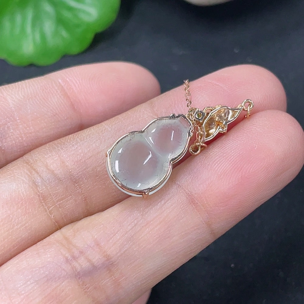 Jadeite inlaid gourd pendant with 18K gold and diamond accents, elegant necklace featuring intricate craftsmanship and luxurious design.