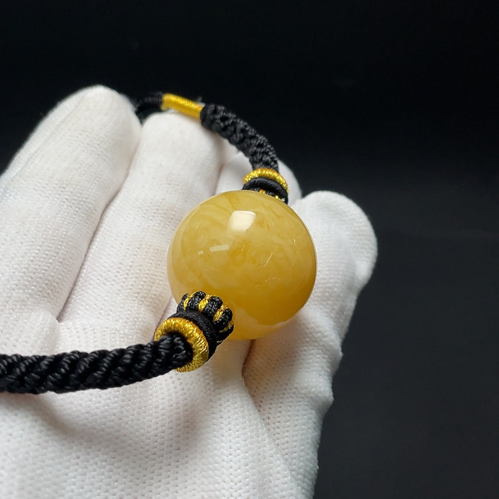 Amber beeswax pendant necklace with cord, approximately 25.2mm in size and 14.39g, from HKHQ featuring natural beeswax design.
