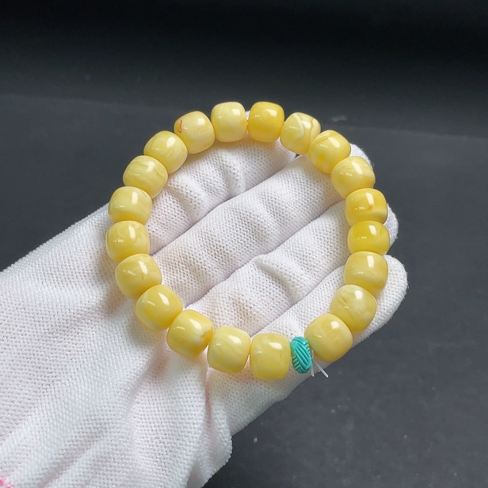 Amber beeswax bracelet with turquoise accents and visible repairs, weighing around 14.1g, featuring 10.4mm beads, by HUILIU HQ.
