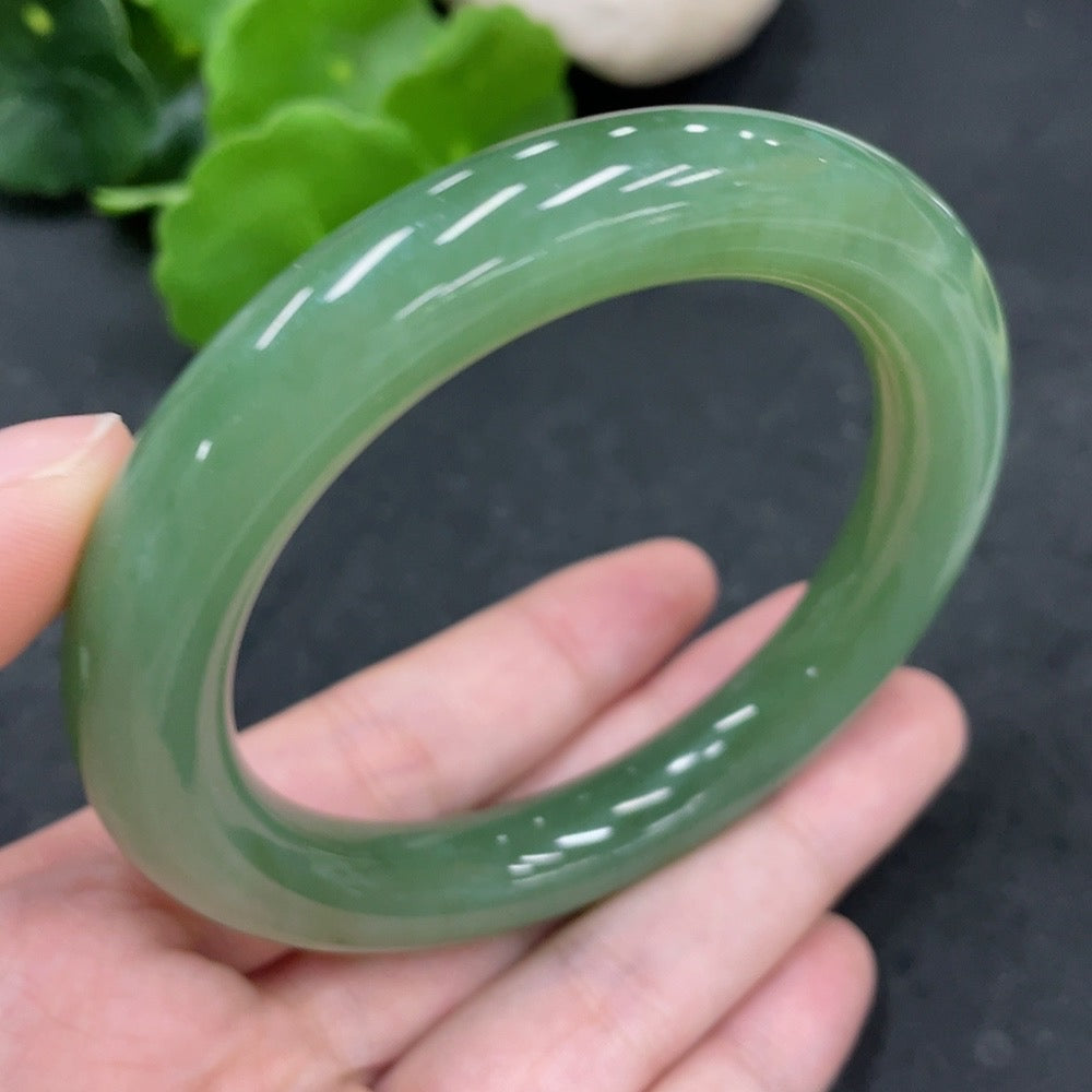 Green Hetian Jade round bangle by HUILIU HQ, 58.6mm size, weighing approximately 65.8g, showcasing polished smooth jade surface.