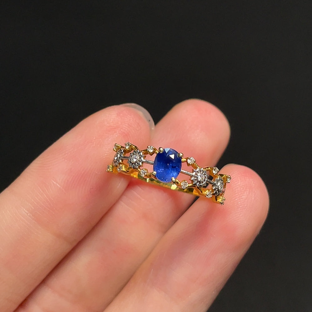 18K blue sapphire ring with diamond accents by HKHQ, showcasing a stunning blue gemstone surrounded by sparkling diamonds.