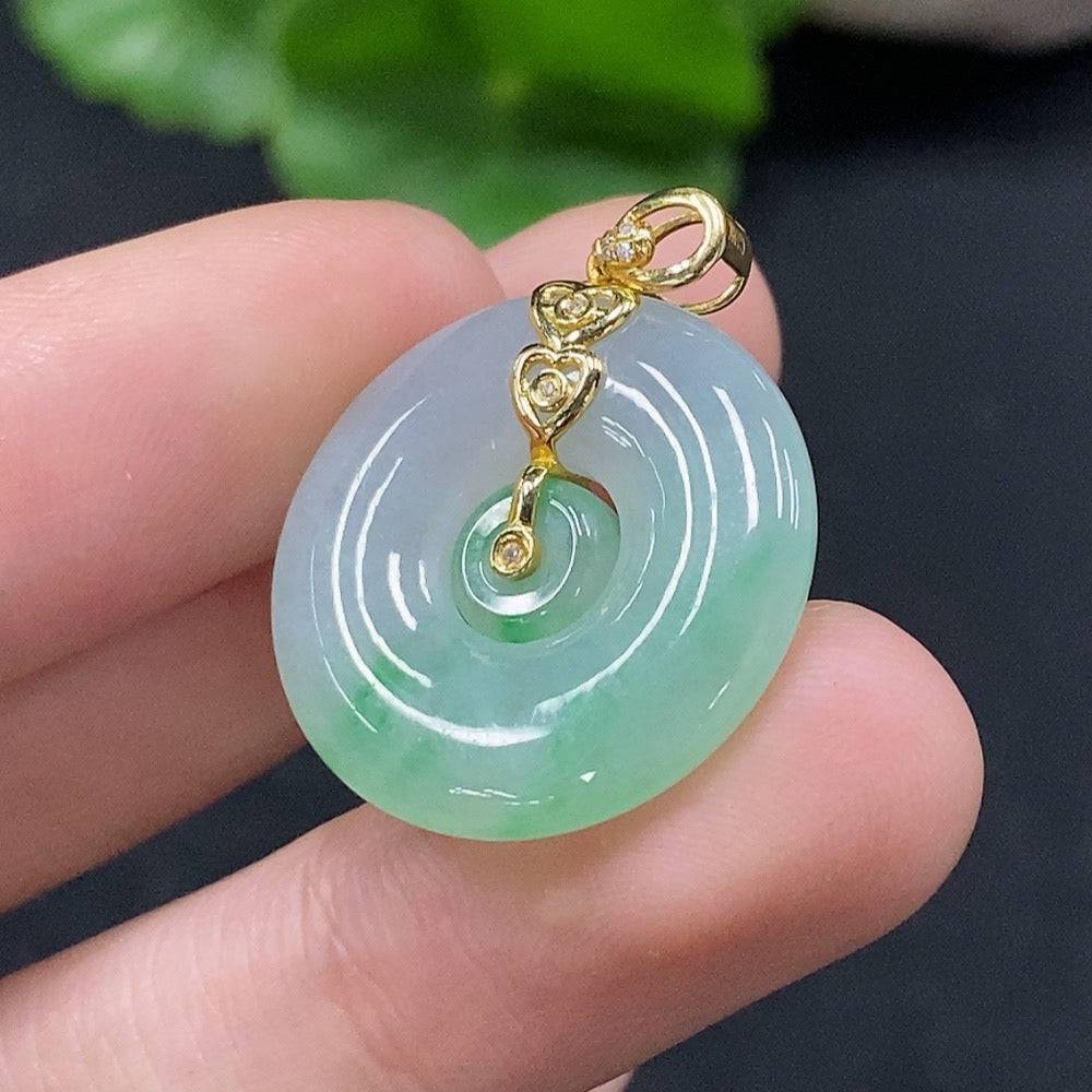 Jadeite mother-and-son button pendant with 18K gold and diamond accents, showcasing intricate craftsmanship and vibrant green jade.