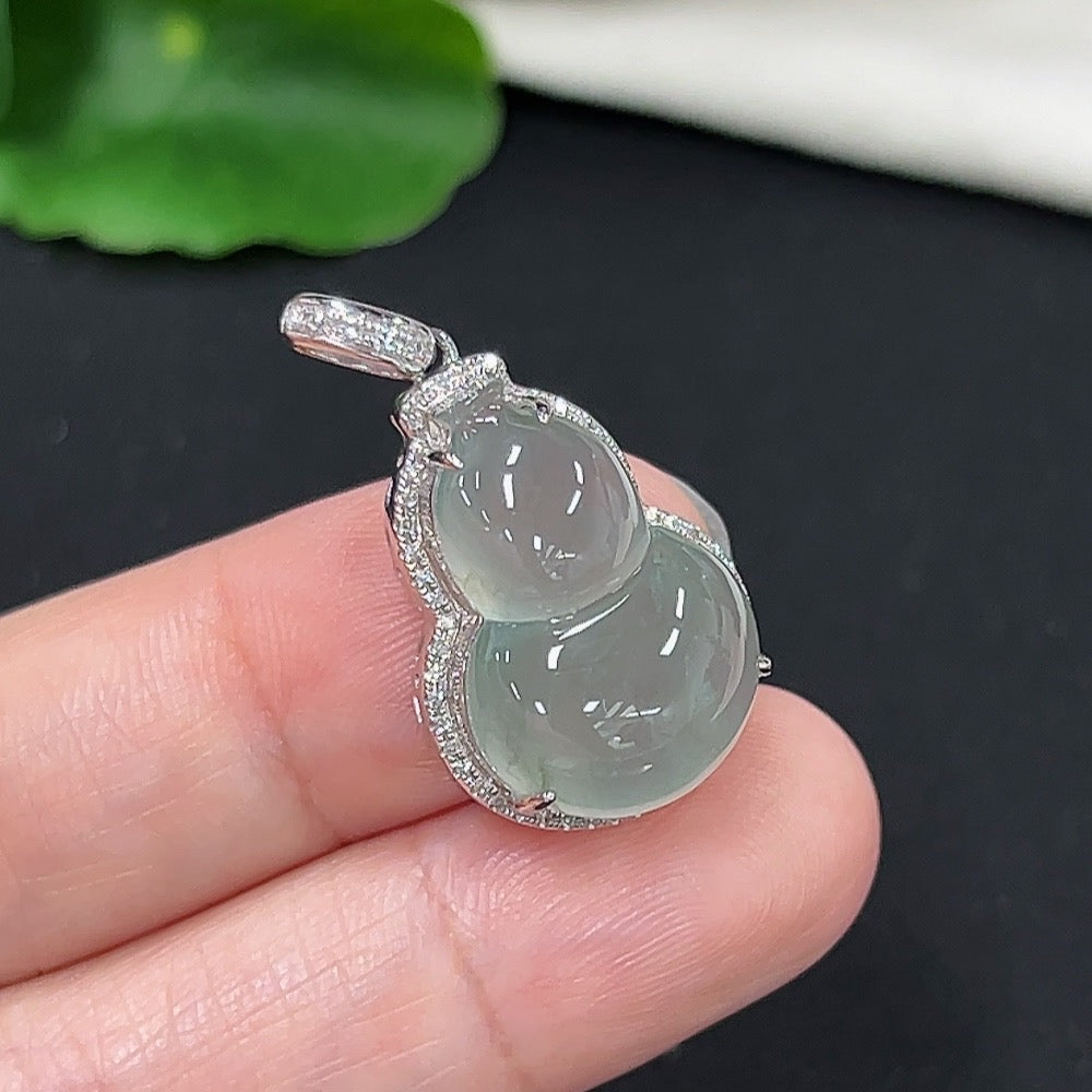 Jadeite gourd inlaid pendant with diamond accents on 9k gold chain, featuring intricate design and polished finish.