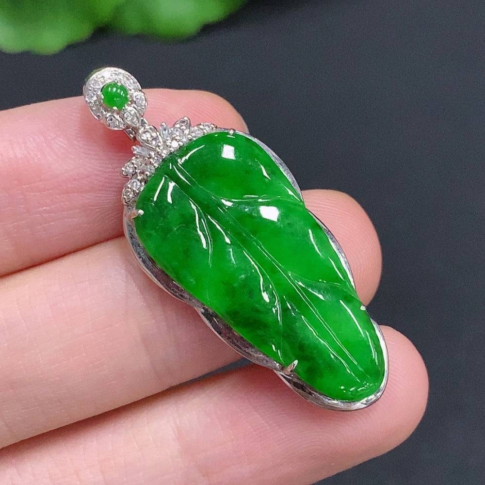 Jadeite leaf pendant with 18k gold and diamond accents, weighing approximately 4g, showcasing intricate leaf design.