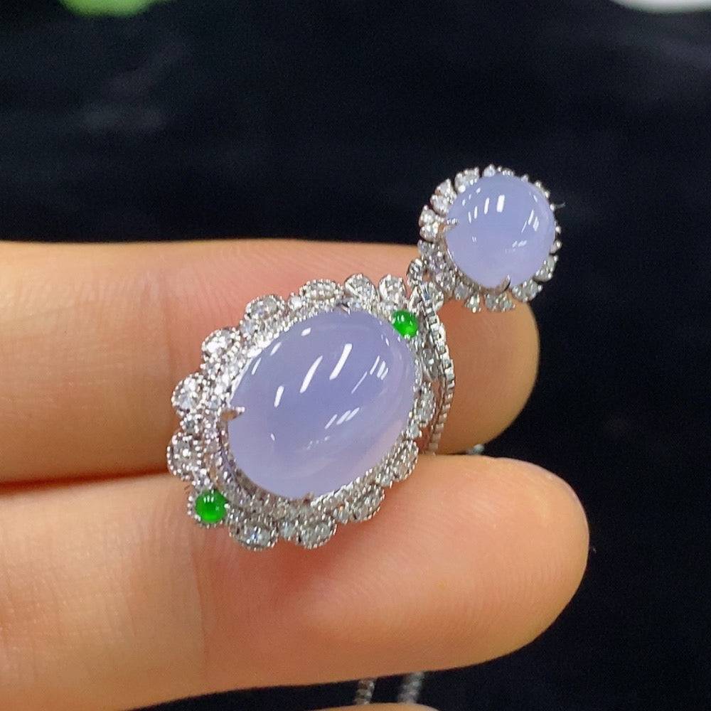 Jadeite cabochon pendant with diamond accents on 18k chain, featuring a green jade gemstone and intricate inlay design.