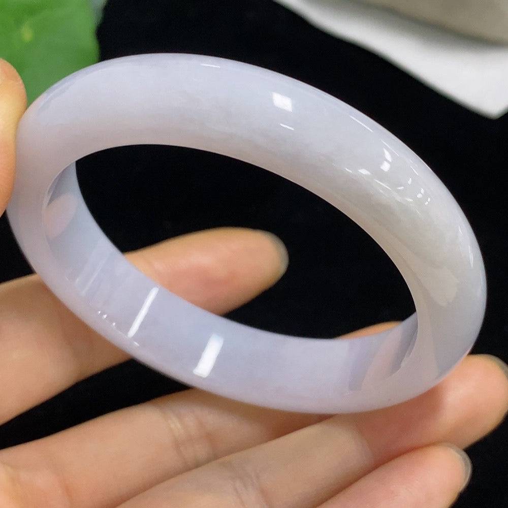 Huiliu Jadeite round bracelet featuring polished green jade beads, certified by HUILIU HQ, on a soft fabric background.