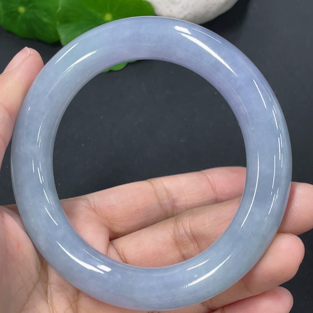 Jadeite round bangle in size 56, weighing approximately 72.67g, featuring a smooth, polished jade surface with subtle natural variations.