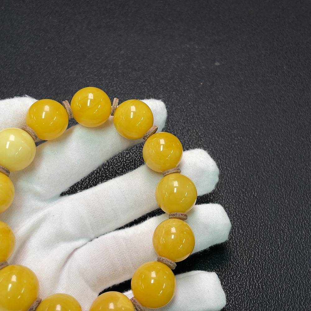 Huiliu amber beeswax bracelet with 16.1mm size, featuring smooth, natural amber beads on a secure elastic band.