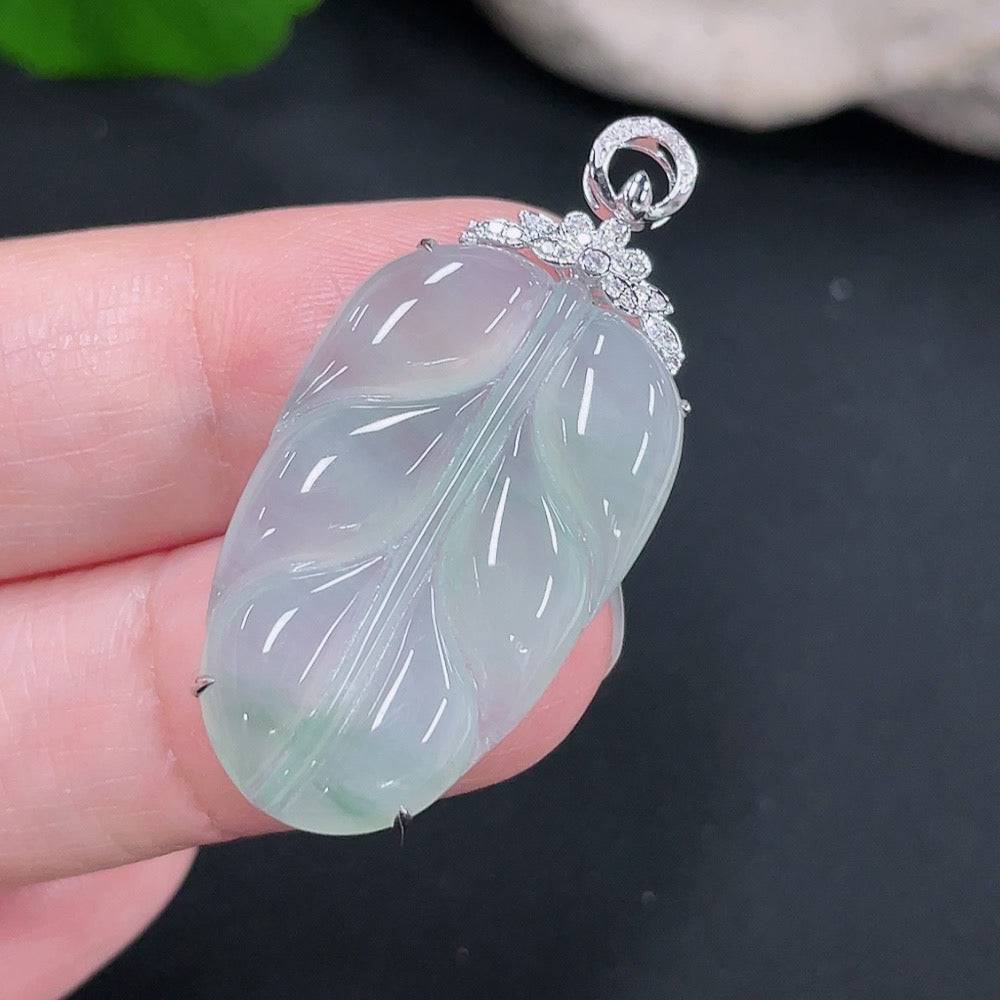 Jadeite pendant in leaf shape with 18k gold and diamond accents, weighing approximately 4.34 grams.