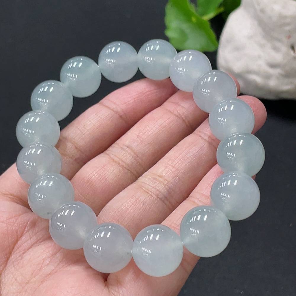 Huiliu certified jadeite bracelet with 13mm smooth, polished jade beads showcasing elegant green coloration.