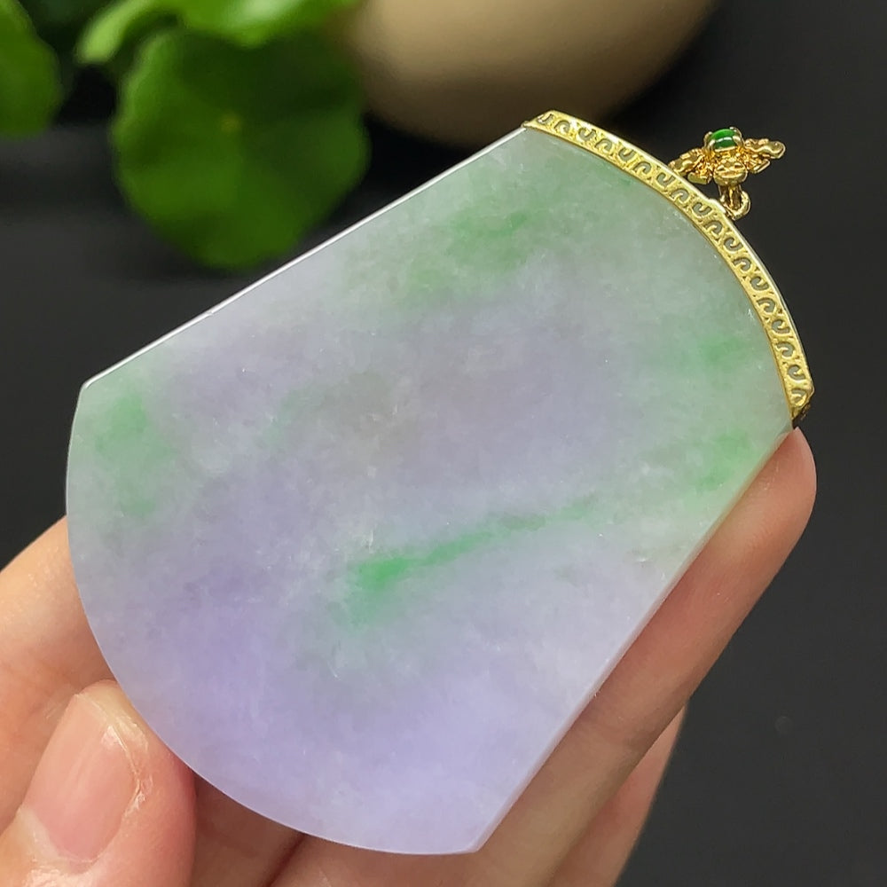 HKHQ jadeite plain pendant mounted in 18k gold, weighing approximately 22.79g, showcasing a smooth, polished jade pendant.