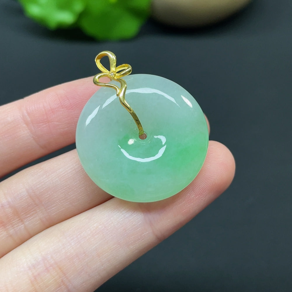 Jadeite Peace Knot pendant with 18k gold, diamond side stones, featuring inlaid jade design, weighing approximately 10.92g.