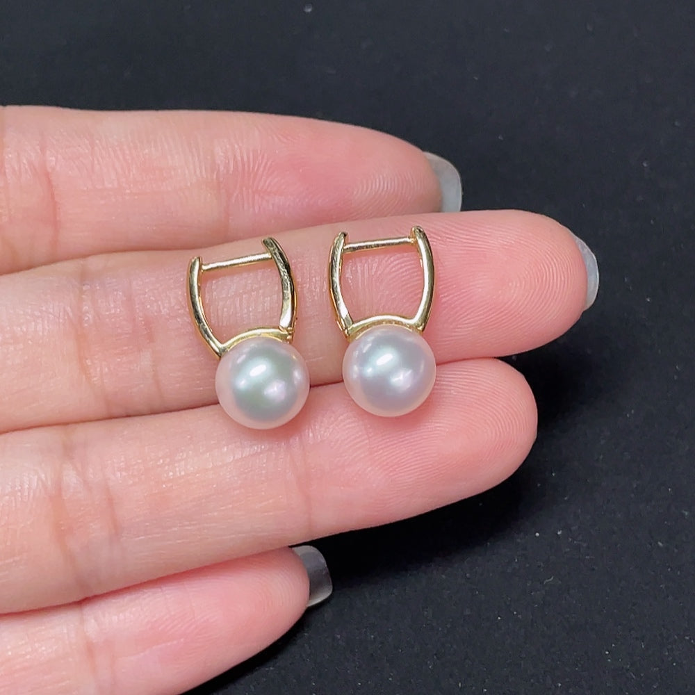 Saltwater pearl earrings with 18K gold settings from HKHQ, showcasing elegant, round pearl drops on delicate gold hooks.