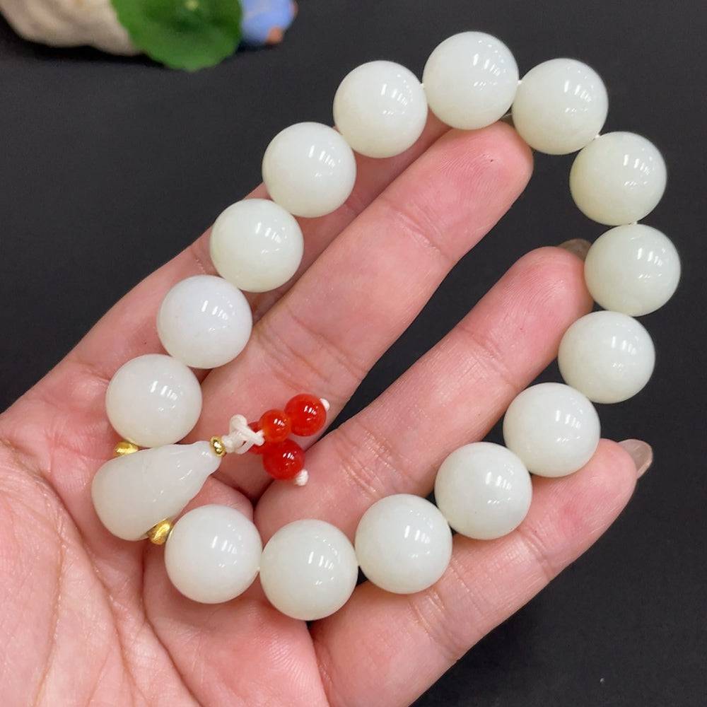 Huiliu Certified Hetian Jade bracelet featuring 13.8mm smooth jade beads with mineral components, natural and polished finish.