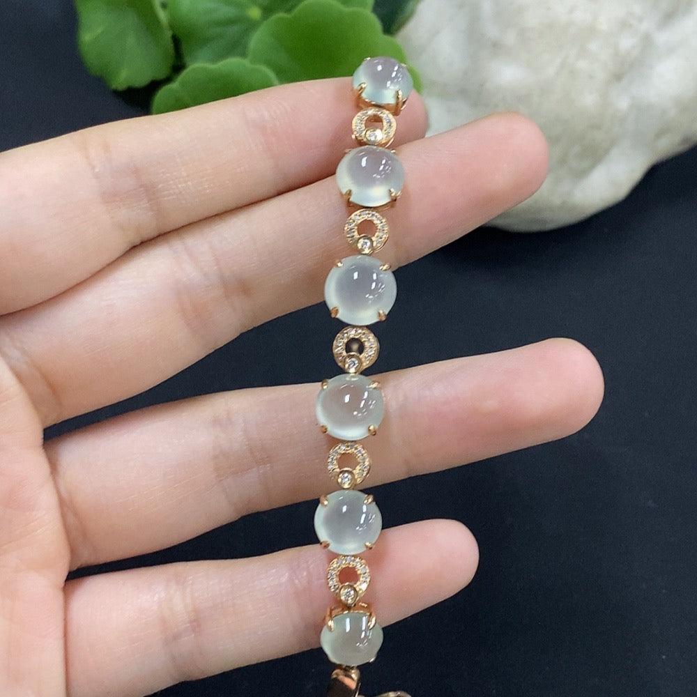 Jadeite cabochon bracelet set in 18K gold with diamond accents, total weight approximately 10.85g