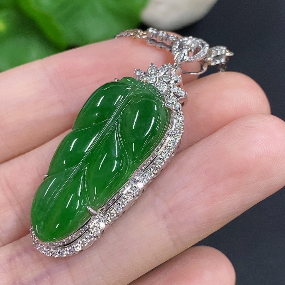 Jadeite leaf pendant with 18K gold and diamond accents, HKHQ, showing detailed jade leaf and gold chain on white background.