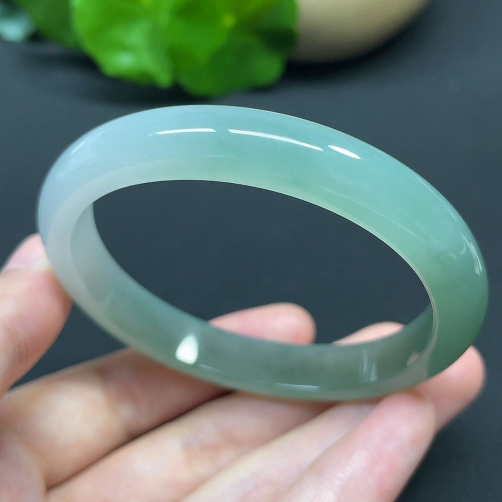 HKHQ jadeite oval bangle in size 55.6 with a weight of 35.37g, showcasing smooth, polished jadeite with a glossy finish.