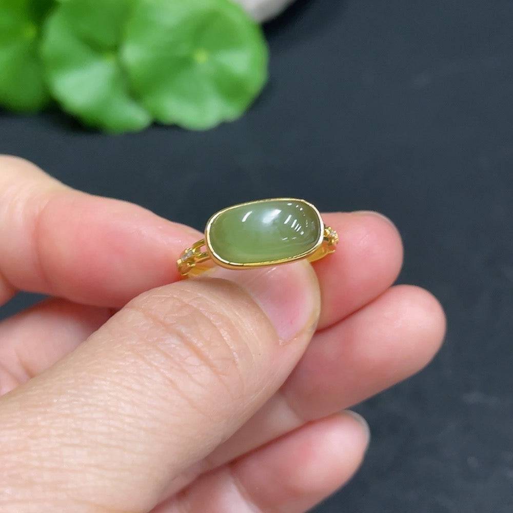 Huiliu certified Hetian jade ring with diamond accents, showcasing intricate inlay work and rich jade content.