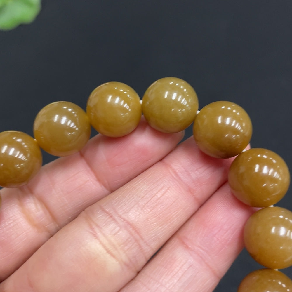 Hetian jade bracelet with 11.6mm beads, crafted by HUILIU HQ, showing smooth green jade stones and elegant design.