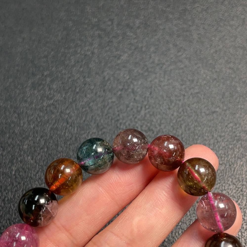Huiliu certified tourmaline bracelet with visible organic matter, 11.7mm gemstone size, showcasing natural gemstone beauty.