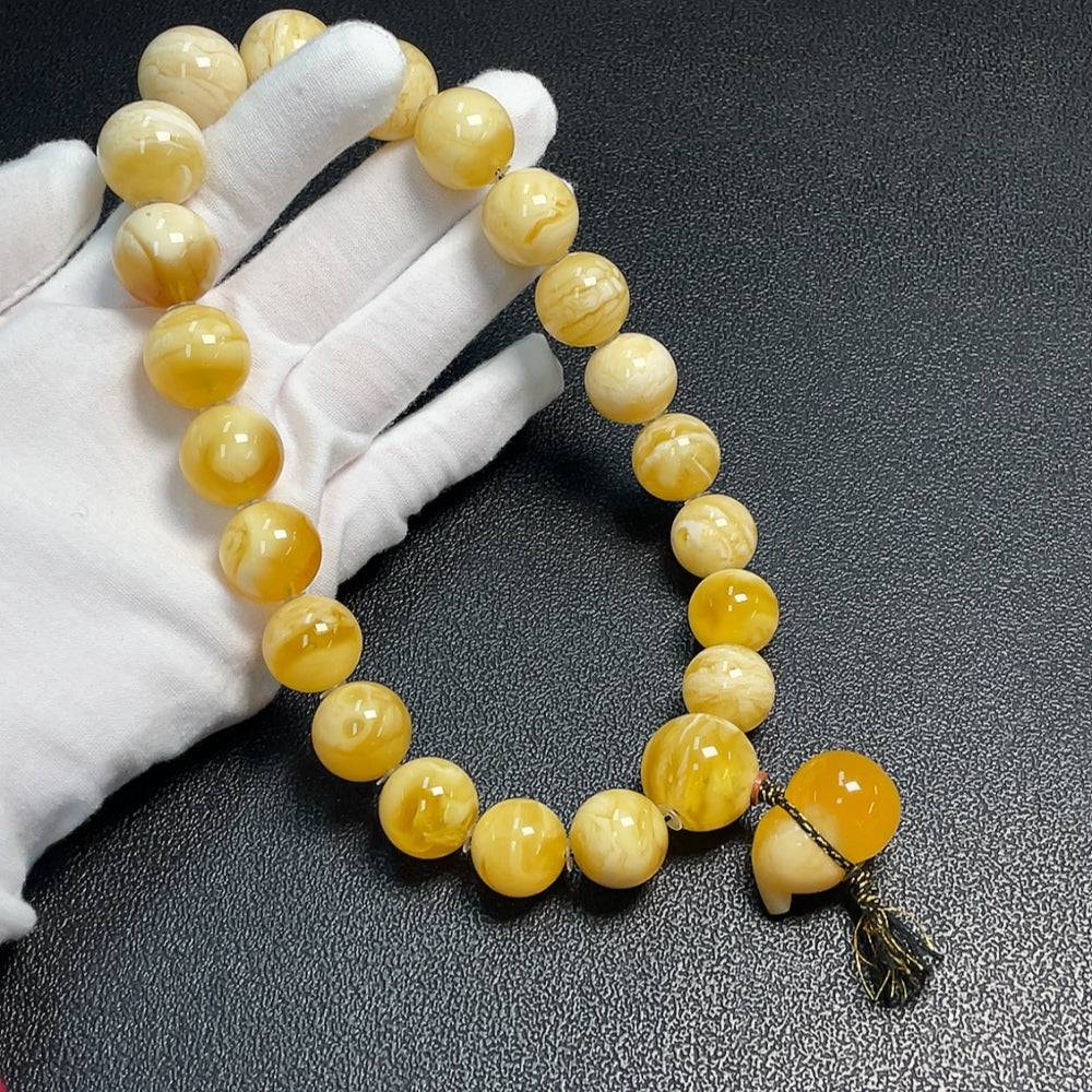 Huiliu amber and beeswax beaded necklace with 29.9mm amber beads, natural, handcrafted jewelry, close-up view.