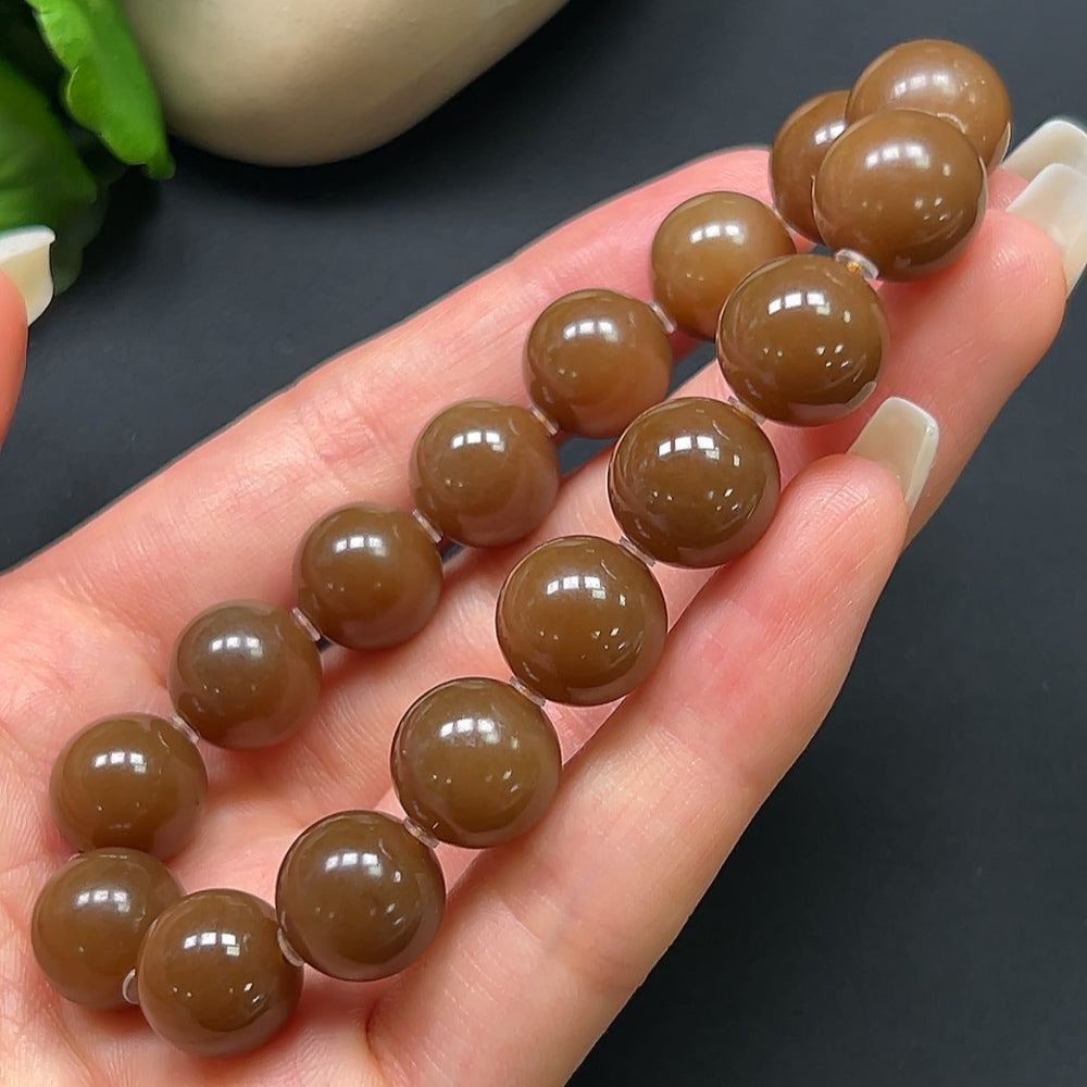 Hetian jade bracelet with 12.1mm beads, weighing approximately 43.69g, featuring polished green jade stones.